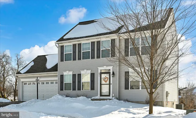a kitchen with granite countertop kitchen island stainless steel appliances a refrigerator a sink and wooden cabinets