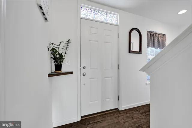 a view of a kitchen area with furniture and wooden floor