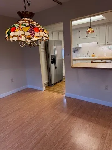 a kitchen with stainless steel appliances granite countertop a sink a refrigerator and a stove