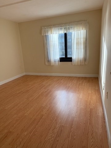 73 Broad Reach, Unit M36C Weymouth, MA 02191 - Photo 14 of 31 an empty room with wooden floor and windows