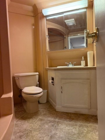 73 Broad Reach, Unit M36C Weymouth, MA 02191 - Photo 20 of 31 a bathroom with a toilet a sink and mirror