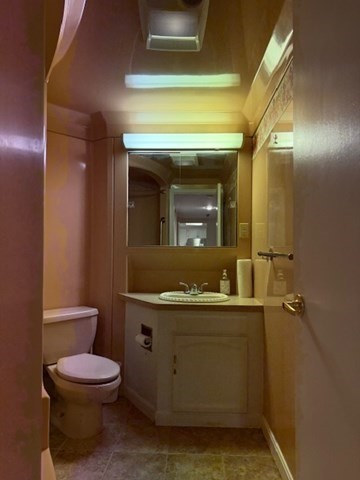 73 Broad Reach, Unit M36C Weymouth, MA 02191 - Photo 21 of 31 a bathroom with a toilet a sink and mirror