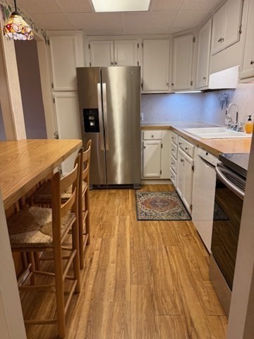 73 Broad Reach, Unit M36C Weymouth, MA 02191 - Photo 8 of 31 a kitchen with stainless steel appliances granite countertop a refrigerator a stove and white cabinets with wooden floors