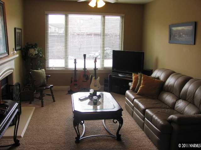 650 Royal Windsor Court Reno, NV 89521 - Photo 4 of 5 a living room with furniture a large window and a flat screen tv