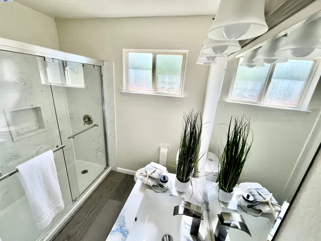 a bathroom with a tub sink and mirror