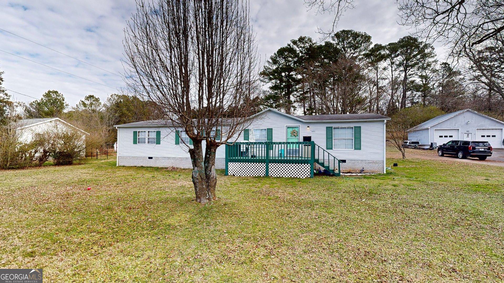 a front view of house with yard and trees