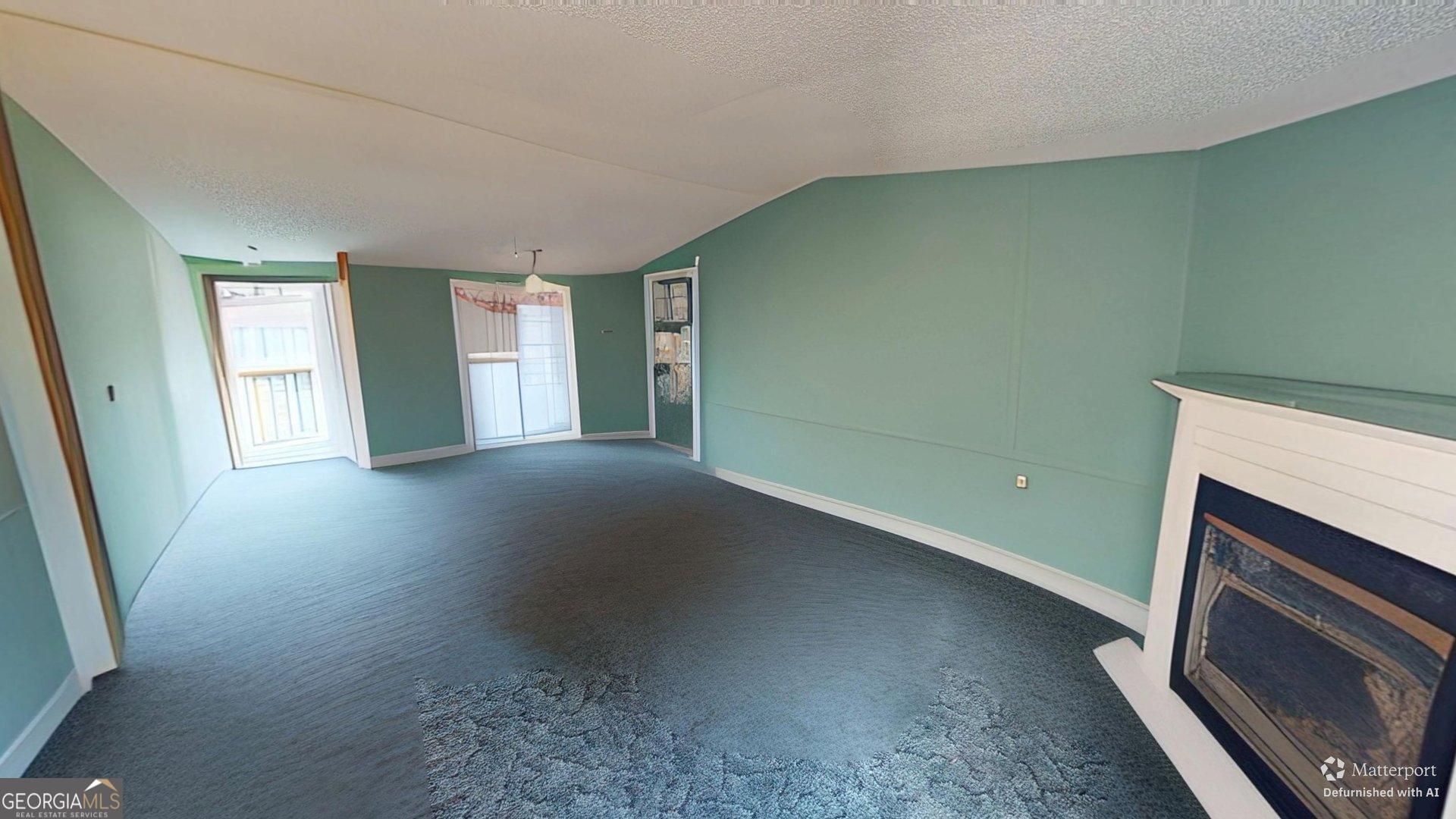 189 Boyd Valley Road Southeast Rome, GA 30161 - Photo 22 of 32 a view of an empty room with a fireplace and a window