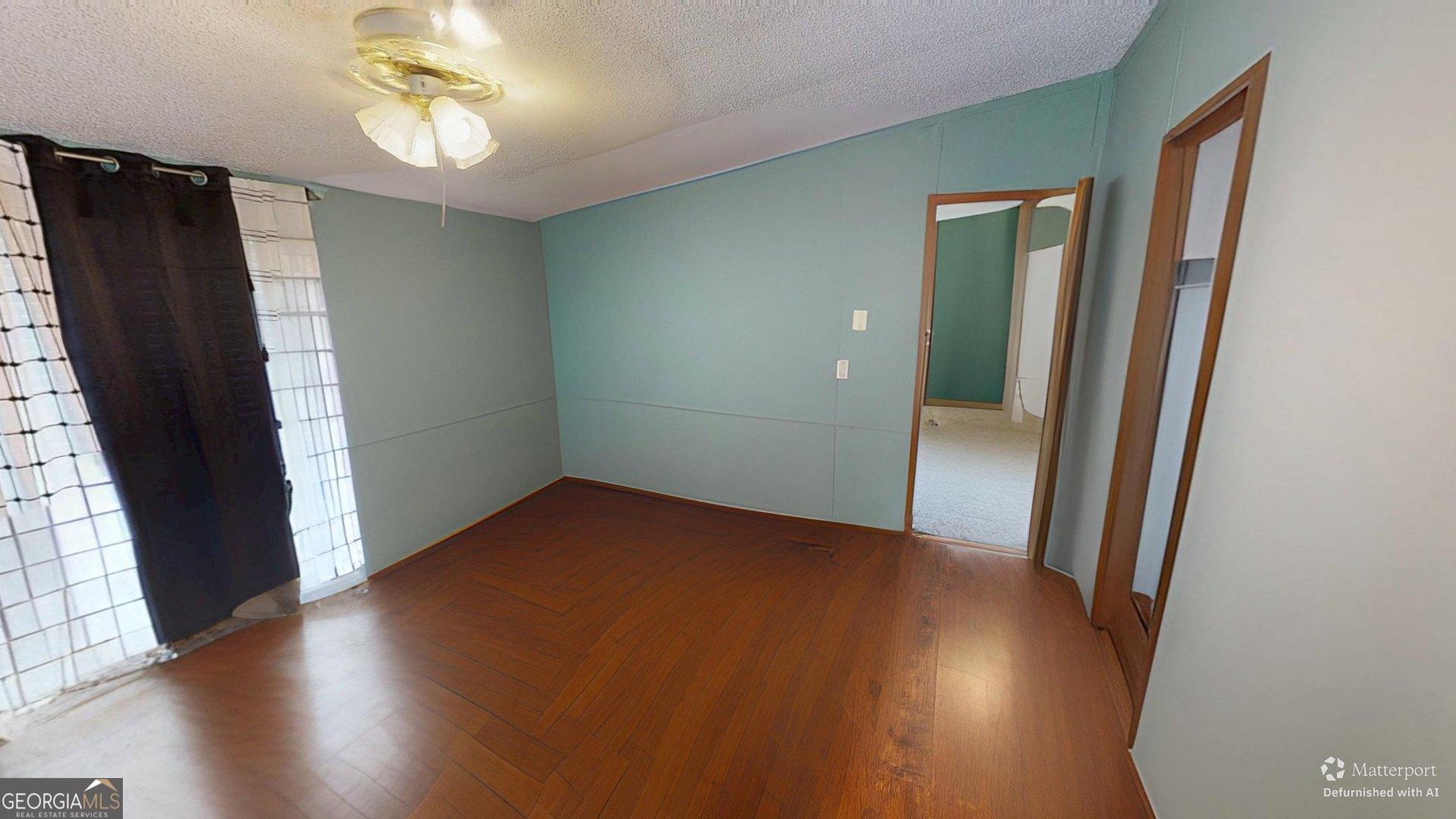 189 Boyd Valley Road Southeast Rome, GA 30161 - Photo 24 of 32 an empty room with wooden floor and windows