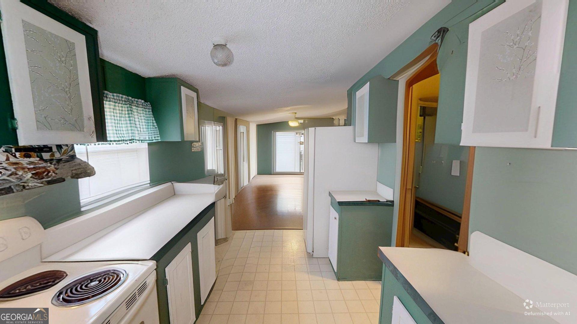 189 Boyd Valley Road Southeast Rome, GA 30161 - Photo 27 of 32 a kitchen with a sink a refrigerator and a stove top oven