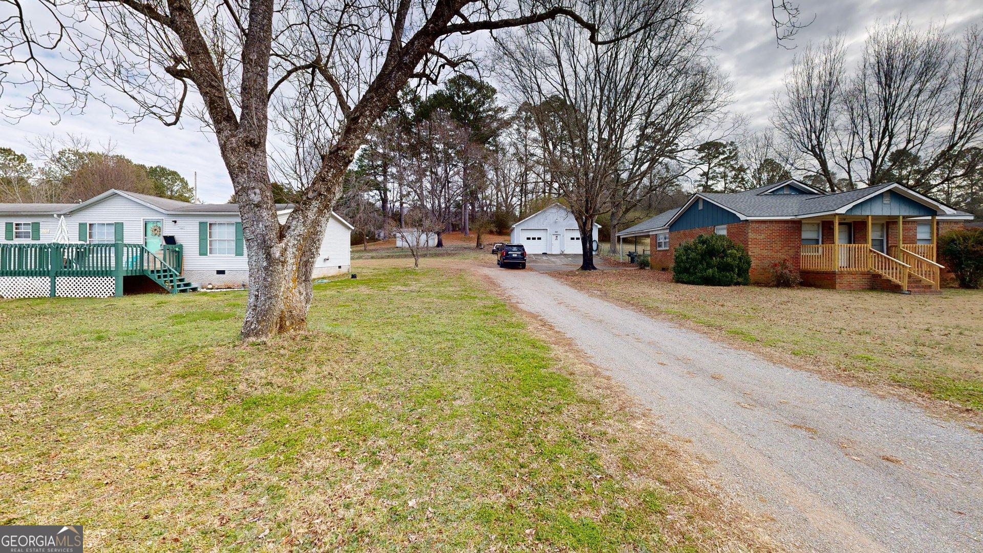 189 Boyd Valley Road Southeast Rome, GA 30161 - Photo 7 of 32 a view of a yard with a large tree in front of the house