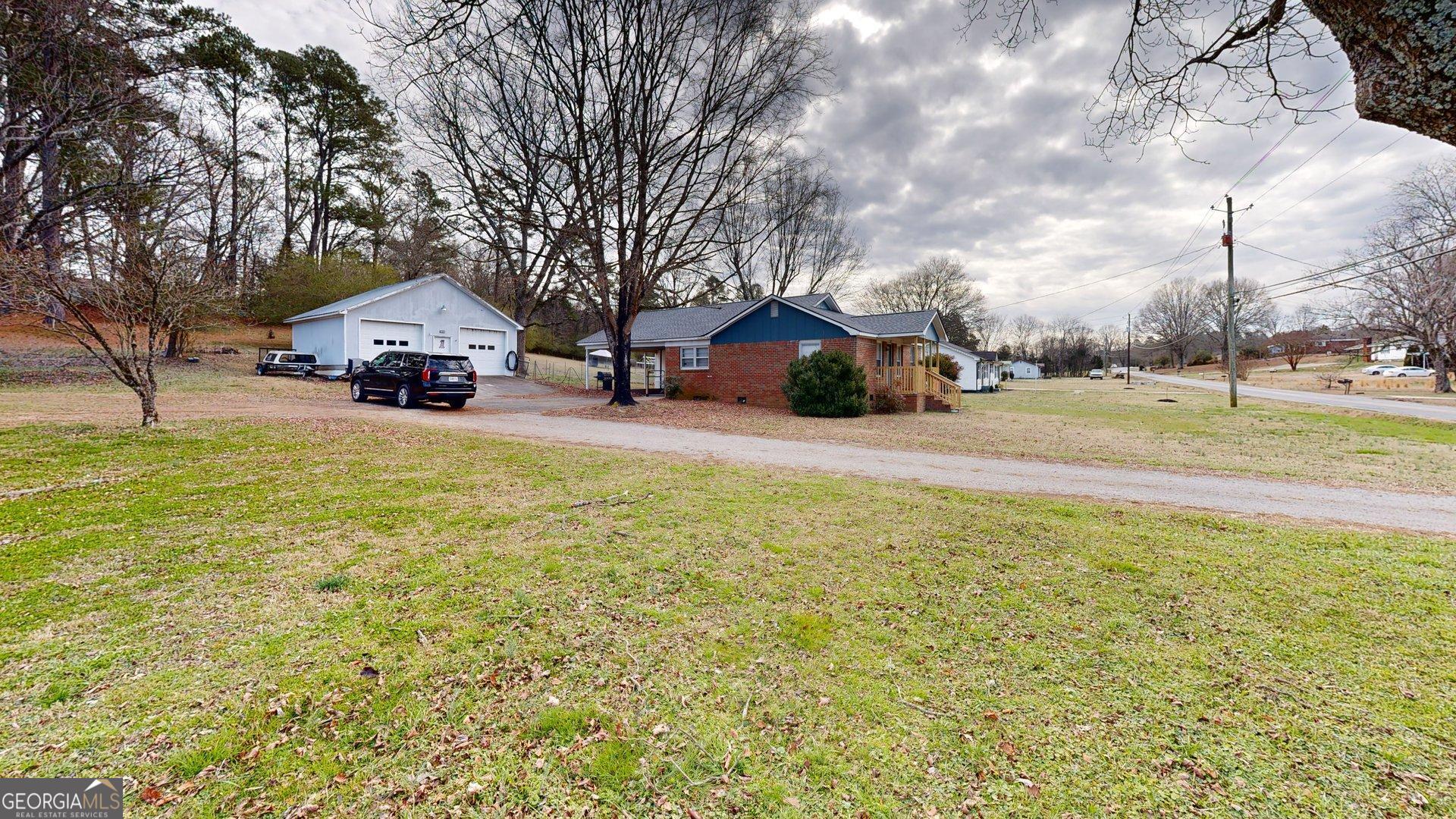 189 Boyd Valley Road Southeast Rome, GA 30161 - Photo 8 of 32 a view of a house with a big yard and large trees