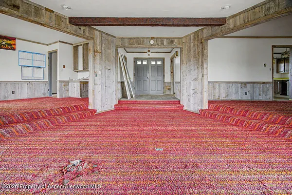 a view of an empty room with windows