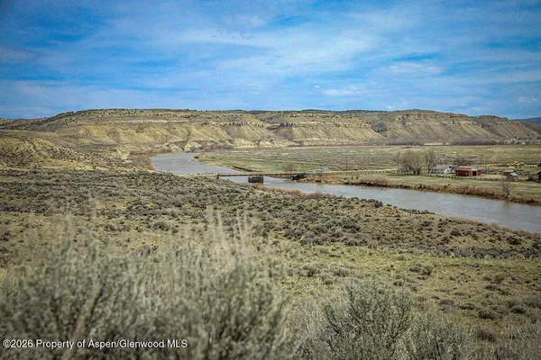 a view of a large building with a yard in back
