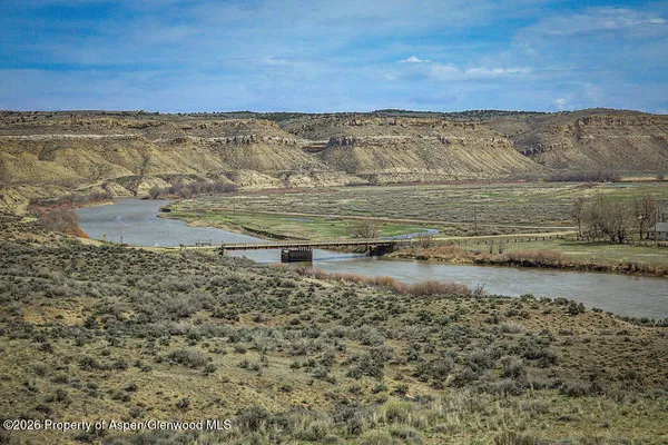 a view of a dry yard with mountains in the background