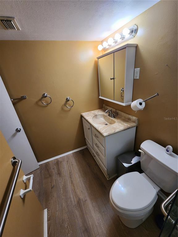 5842 Welcome Road, Unit J2 Bradenton, FL 34207 - Photo 14 of 25 a bathroom with a toilet sink and mirror