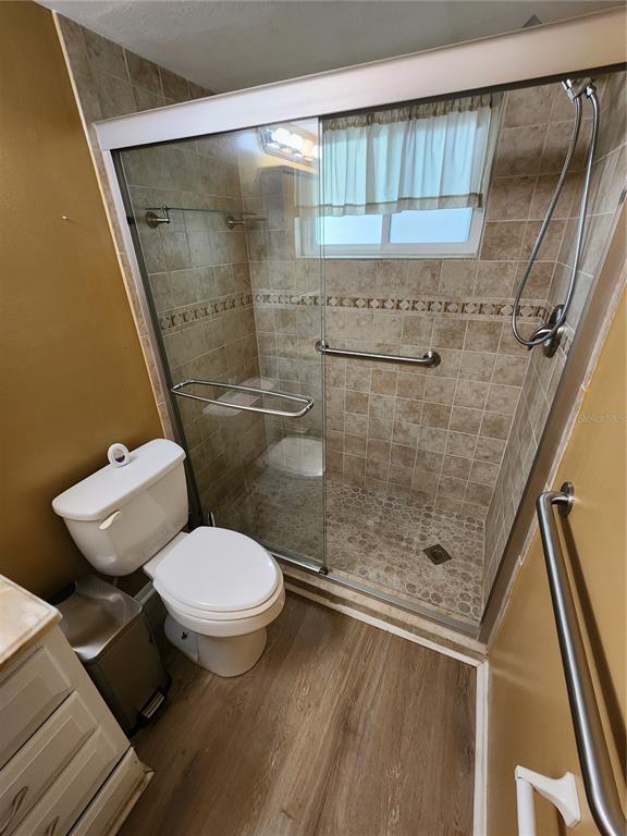 5842 Welcome Road, Unit J2 Bradenton, FL 34207 - Photo 15 of 25 a bathroom with a toilet and a shower
