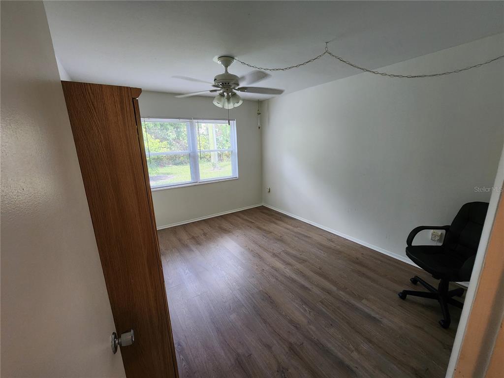 5842 Welcome Road, Unit J2 Bradenton, FL 34207 - Photo 19 of 25 wooden floor in an empty room with a window