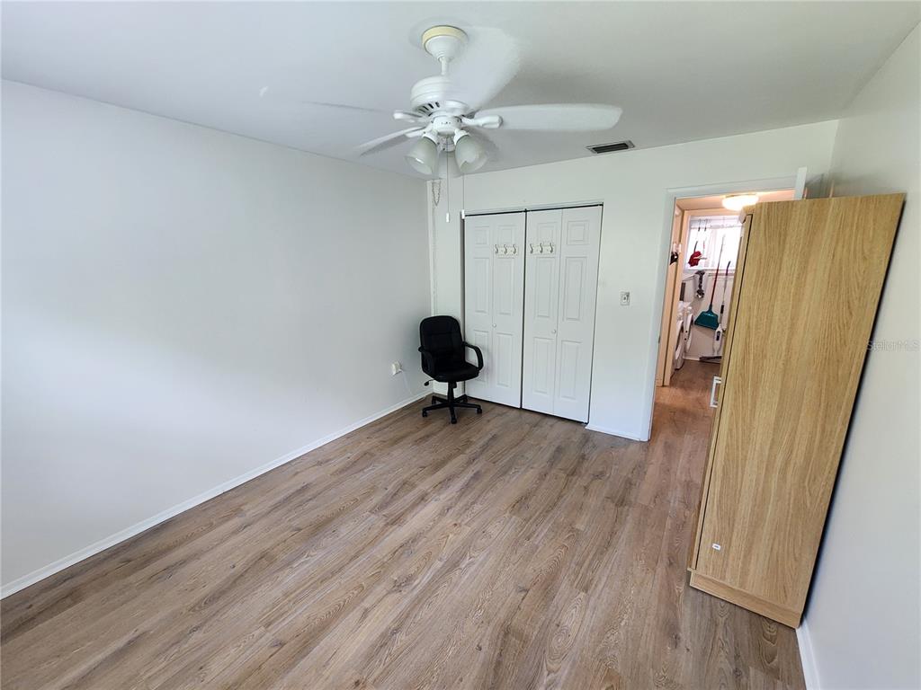 5842 Welcome Road, Unit J2 Bradenton, FL 34207 - Photo 20 of 25 a view of a room with wooden floor and white walls