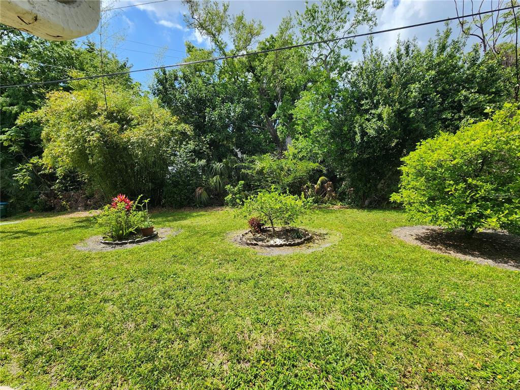 5842 Welcome Road, Unit J2 Bradenton, FL 34207 - Photo 25 of 25 a view of a garden with a slide