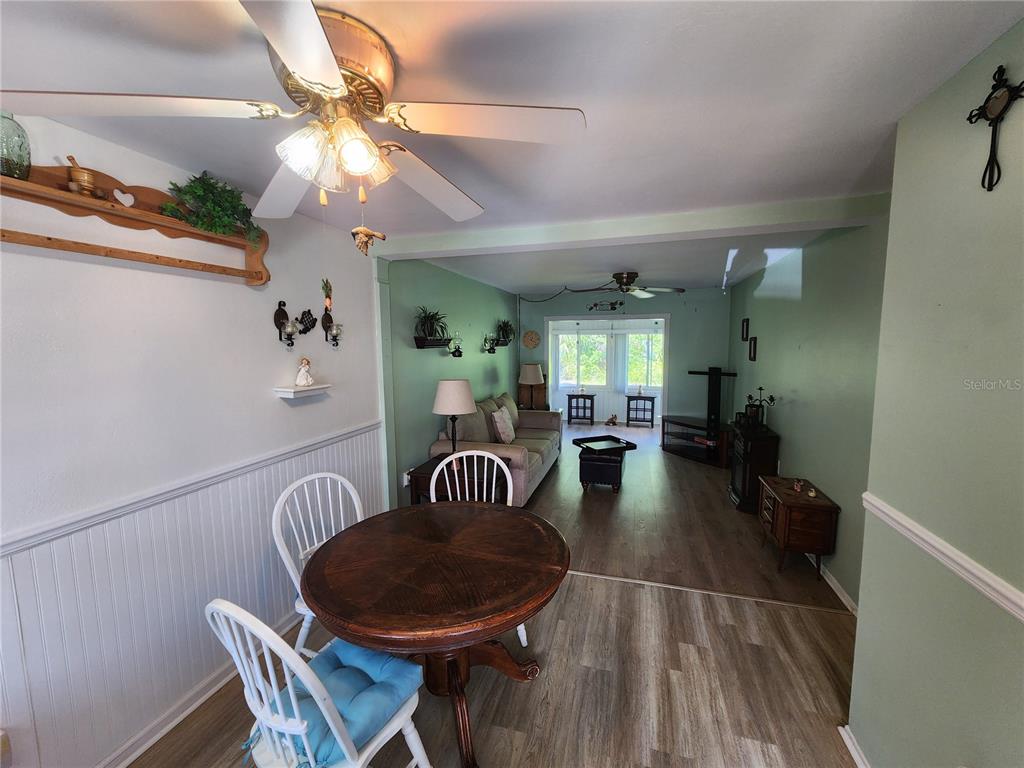 5842 Welcome Road, Unit J2 Bradenton, FL 34207 - Photo 3 of 25 a dining room with furniture and wooden floor