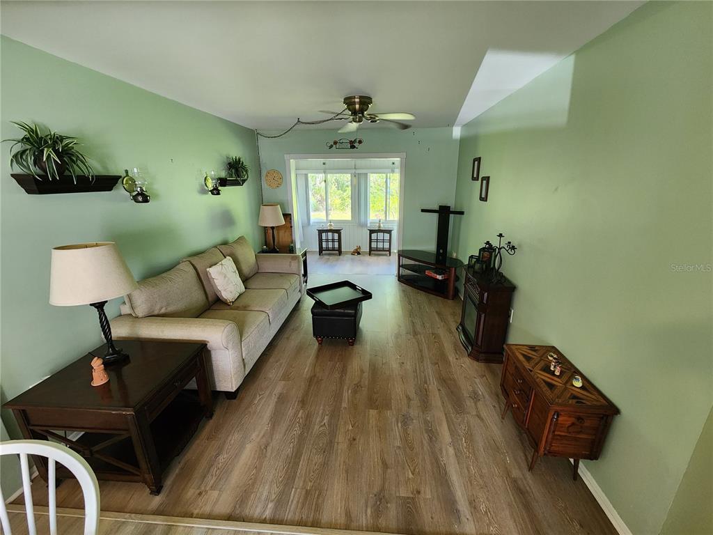 5842 Welcome Road, Unit J2 Bradenton, FL 34207 - Photo 4 of 25 a living room with furniture and a wooden floor