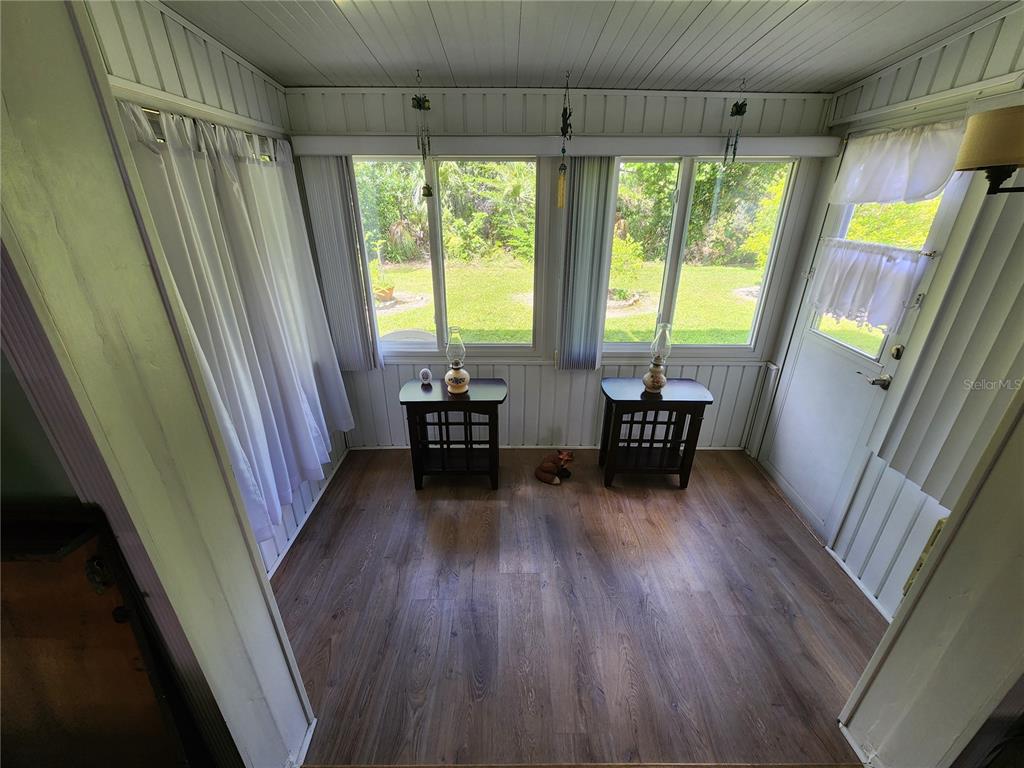 5842 Welcome Road, Unit J2 Bradenton, FL 34207 - Photo 5 of 25 a room with wooden floor and furniture