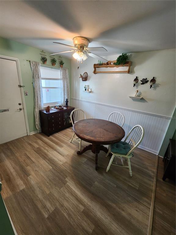 5842 Welcome Road, Unit J2 Bradenton, FL 34207 - Photo 7 of 25 a view of a dining room with furniture and wooden floor