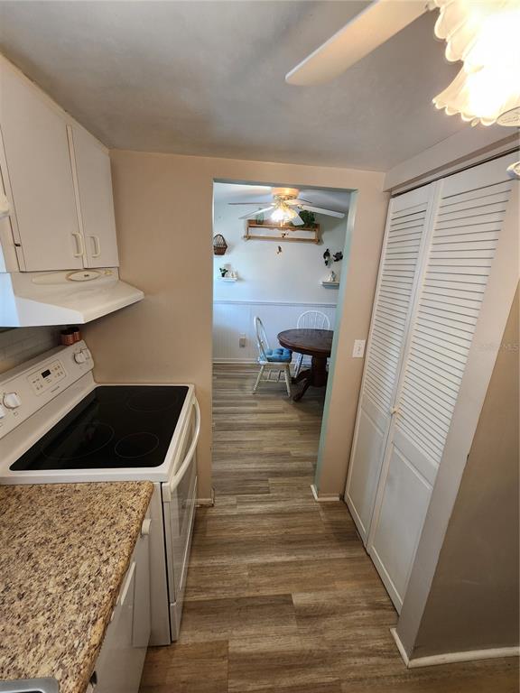 5842 Welcome Road, Unit J2 Bradenton, FL 34207 - Photo 10 of 25 a kitchen with a refrigerator and a stove