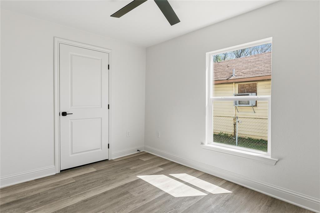 815 Garrison Street Waco, TX 76704 - Photo 25 of 36 an empty room with a window and wooden floor