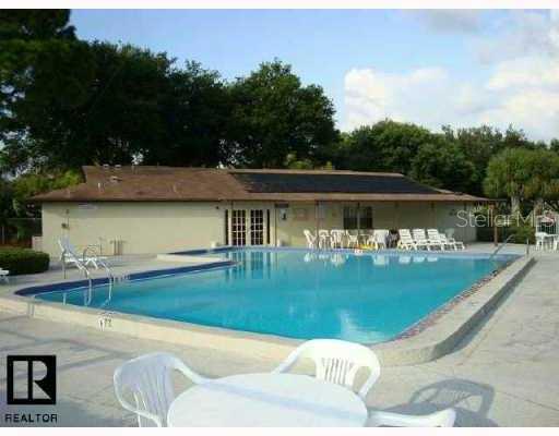 2444 Enterprise Road, Unit 11 Clearwater, FL 33763 - Photo 1 of 1 a view of a swimming pool with a garden