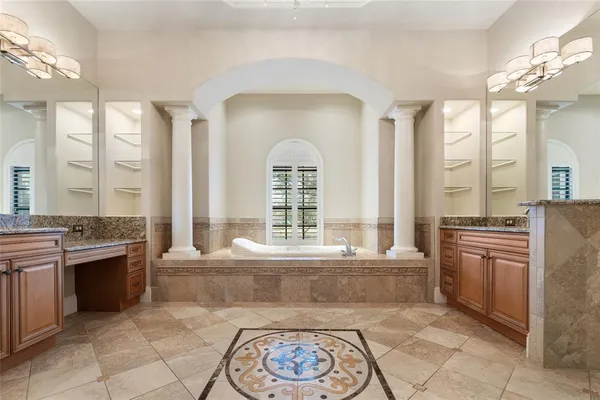 a spacious bathroom with a granite countertop tub sink and mirror