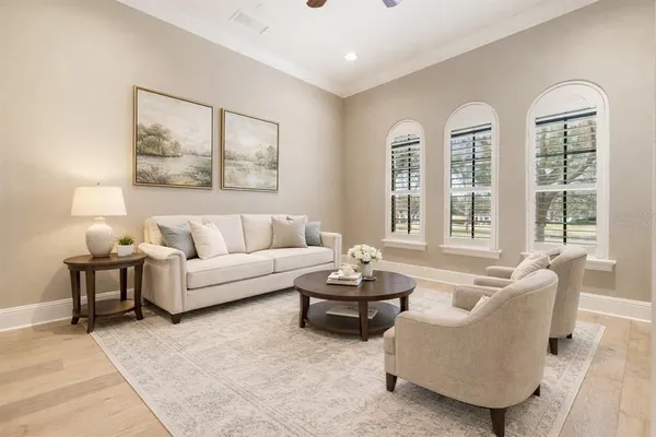 a living room with furniture and floor to ceiling windows
