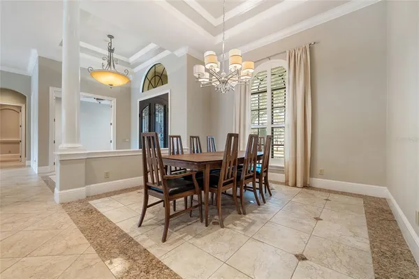 a view of a dining room with furniture and a chandelier