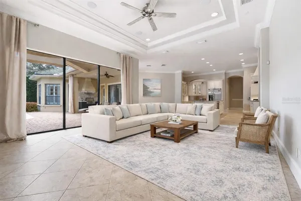a living room with furniture and a chandelier