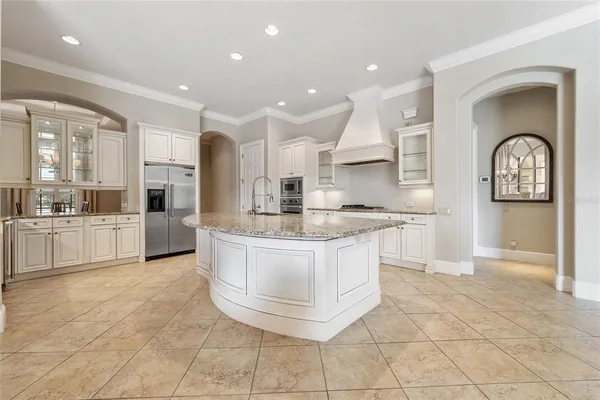 a view of kitchen with granite countertop lots of white stainless steel appliances