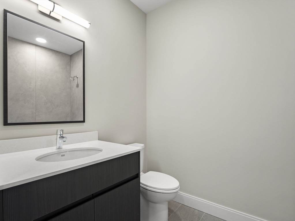 249 Corey Road, Unit 401 Boston, MA 02135 - Photo 23 of 34 a bathroom with a sink and a toilet