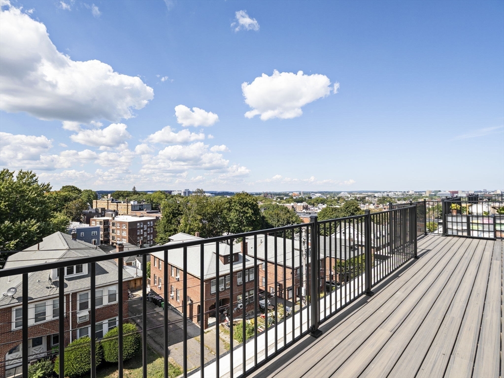 249 Corey Road, Unit 401 Boston, MA 02135 - Photo 26 of 34 a view of a balcony with wooden floor