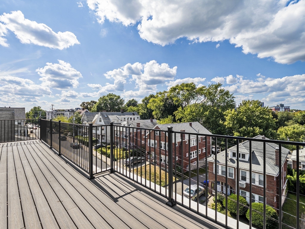 249 Corey Road, Unit 401 Boston, MA 02135 - Photo 28 of 34 a view of a balcony with wooden floor
