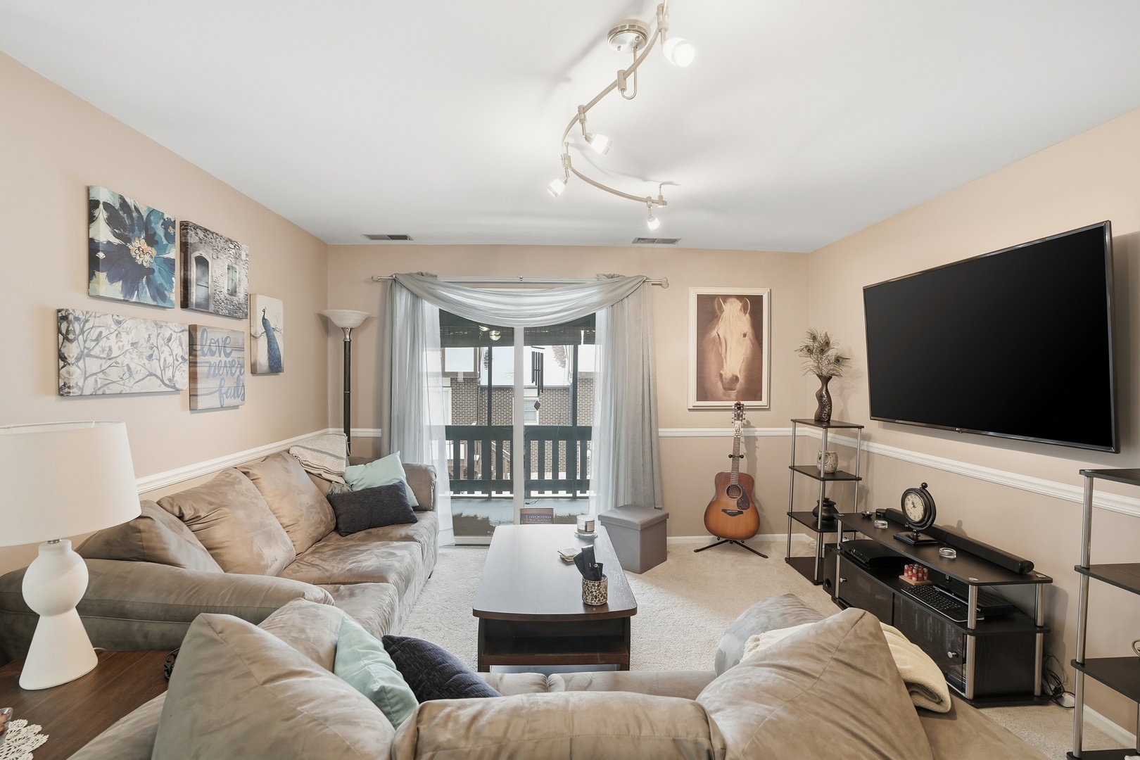 917 Patricia Lane, Unit 917 Crete, IL 60417 - Photo 3 of 17 a living room with furniture and a flat screen tv