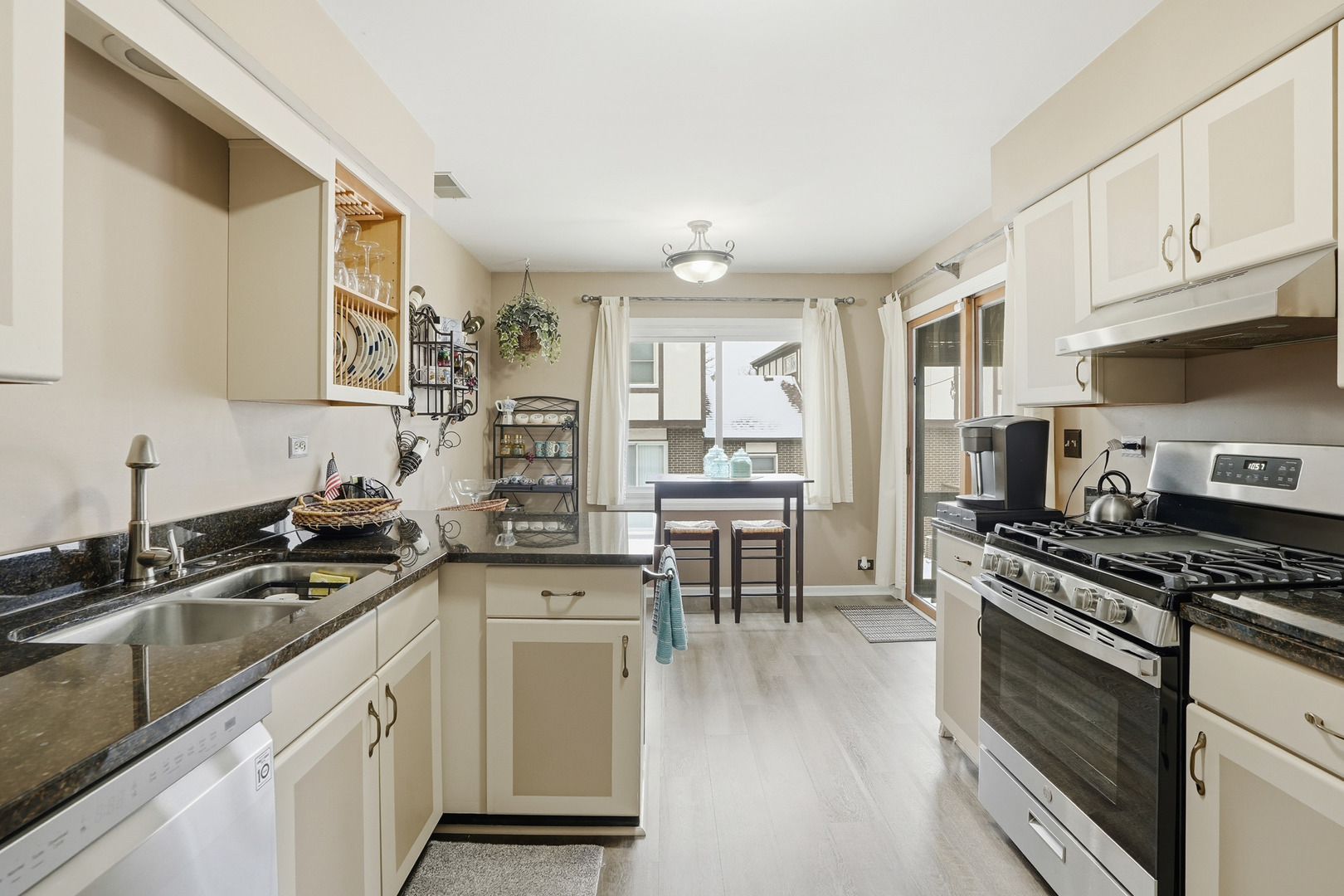 917 Patricia Lane, Unit 917 Crete, IL 60417 - Photo 5 of 17 a kitchen with granite countertop a sink cabinets stainless steel appliances and a window