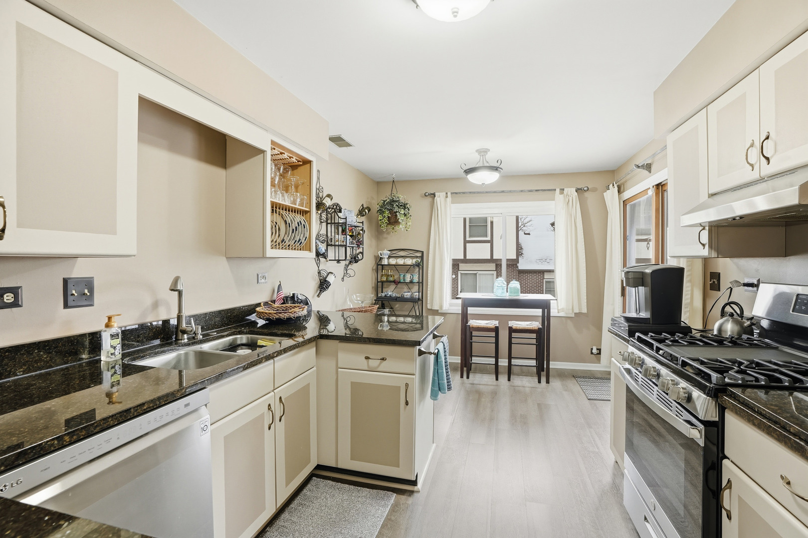 917 Patricia Lane, Unit 917 Crete, IL 60417 - Photo 6 of 17 a kitchen with stainless steel appliances a stove sink and cabinets
