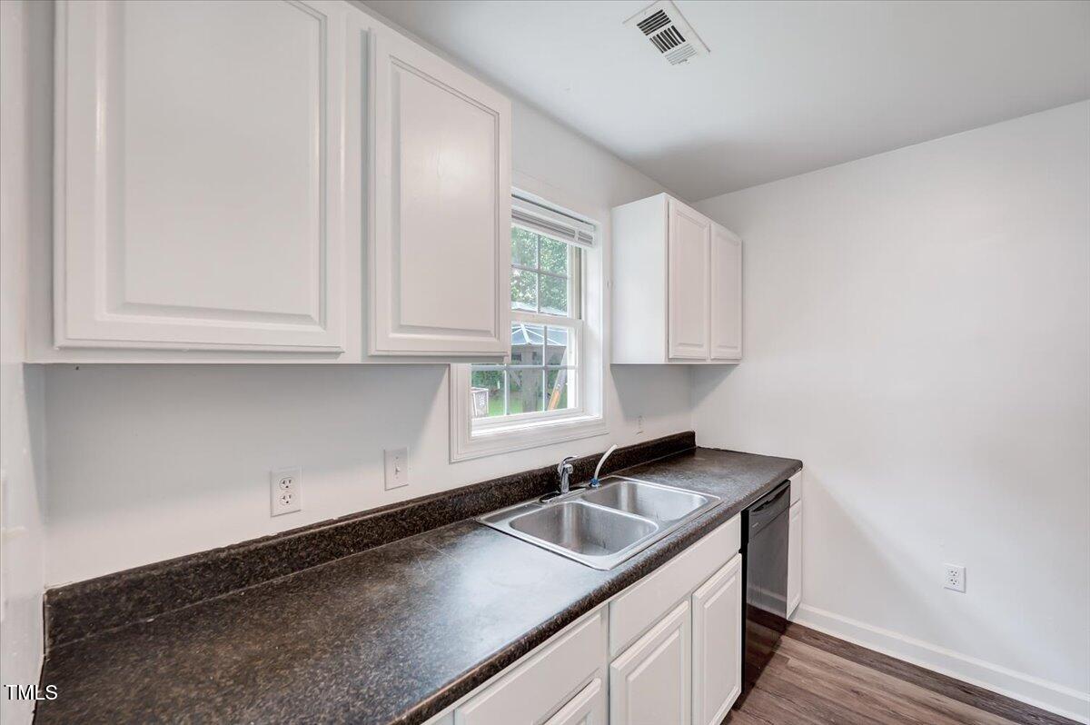 216 Katie Drive Rocky Mount, NC 27803 - Photo 12 of 27 a kitchen with stainless steel appliances granite countertop a sink a stove and a granite counter tops with white cabinets
