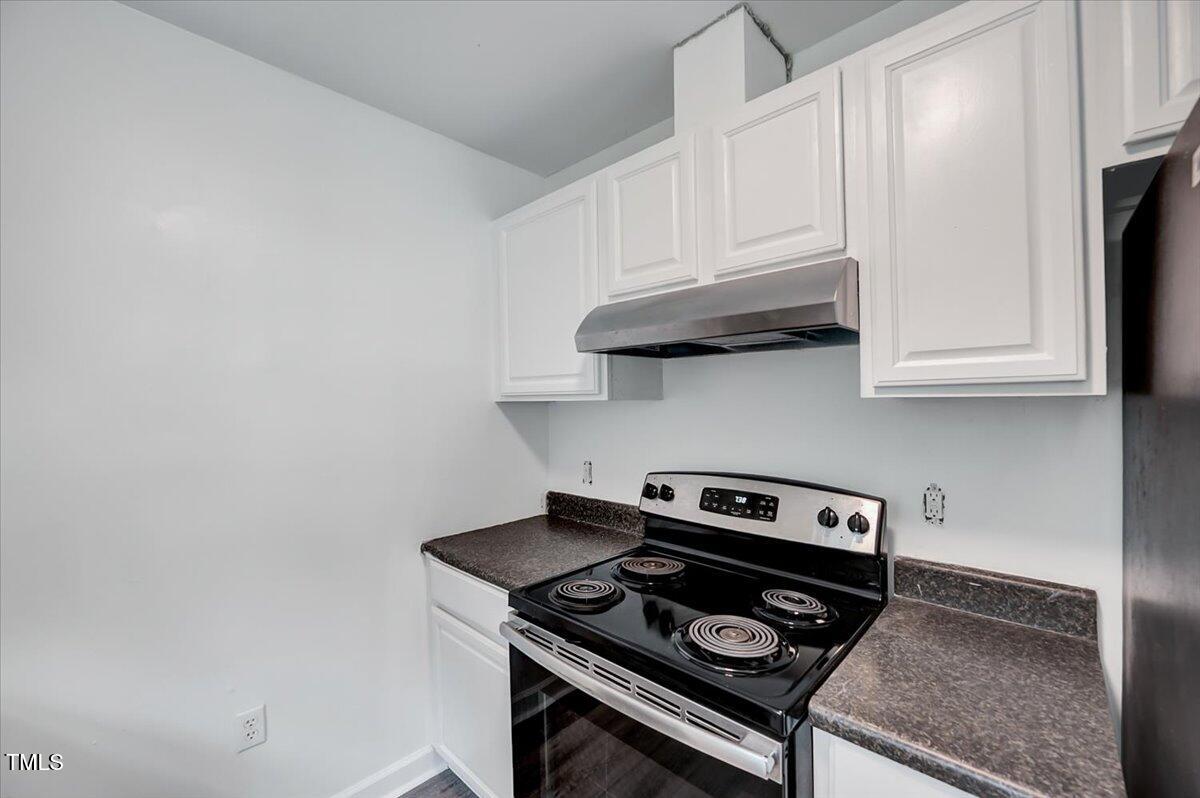216 Katie Drive Rocky Mount, NC 27803 - Photo 14 of 27 a kitchen with stainless steel appliances granite countertop white cabinets and a stove top oven