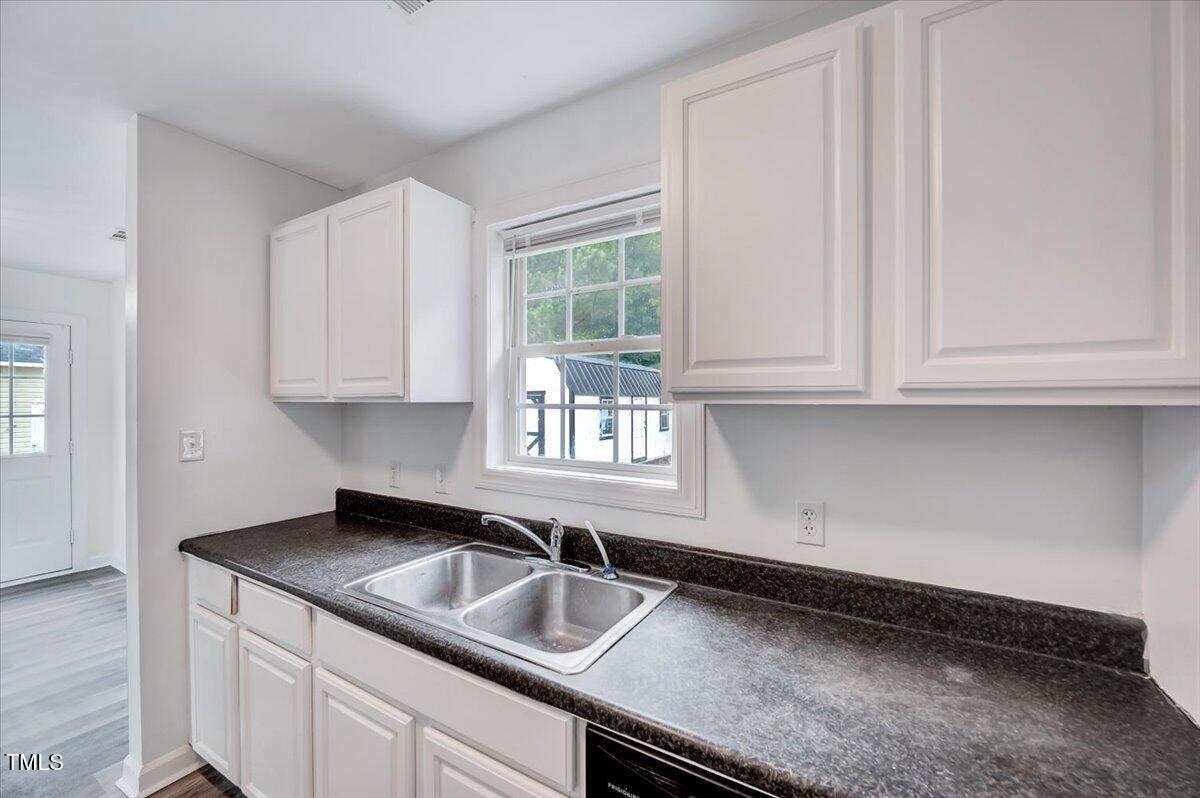 216 Katie Drive Rocky Mount, NC 27803 - Photo 15 of 27 a kitchen with granite countertop white cabinets sink and window