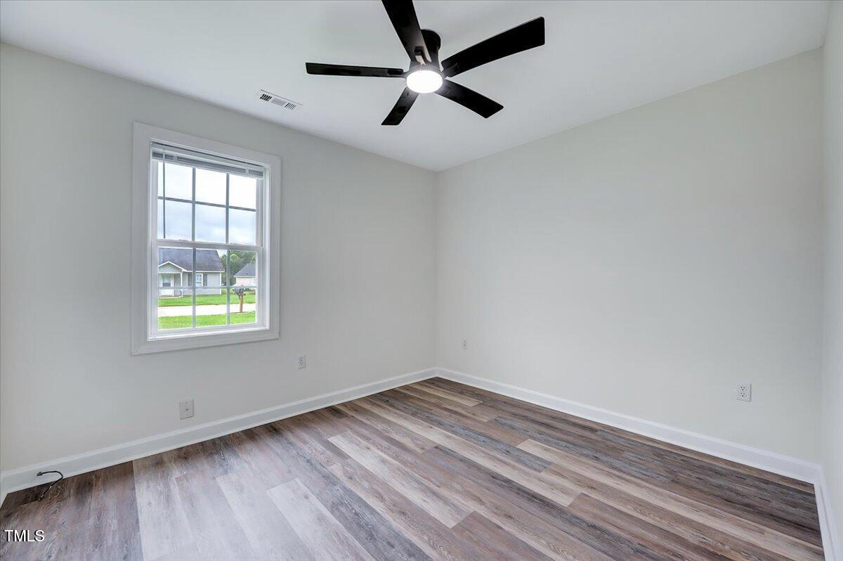 216 Katie Drive Rocky Mount, NC 27803 - Photo 20 of 27 an empty room with a window and a ceiling fan