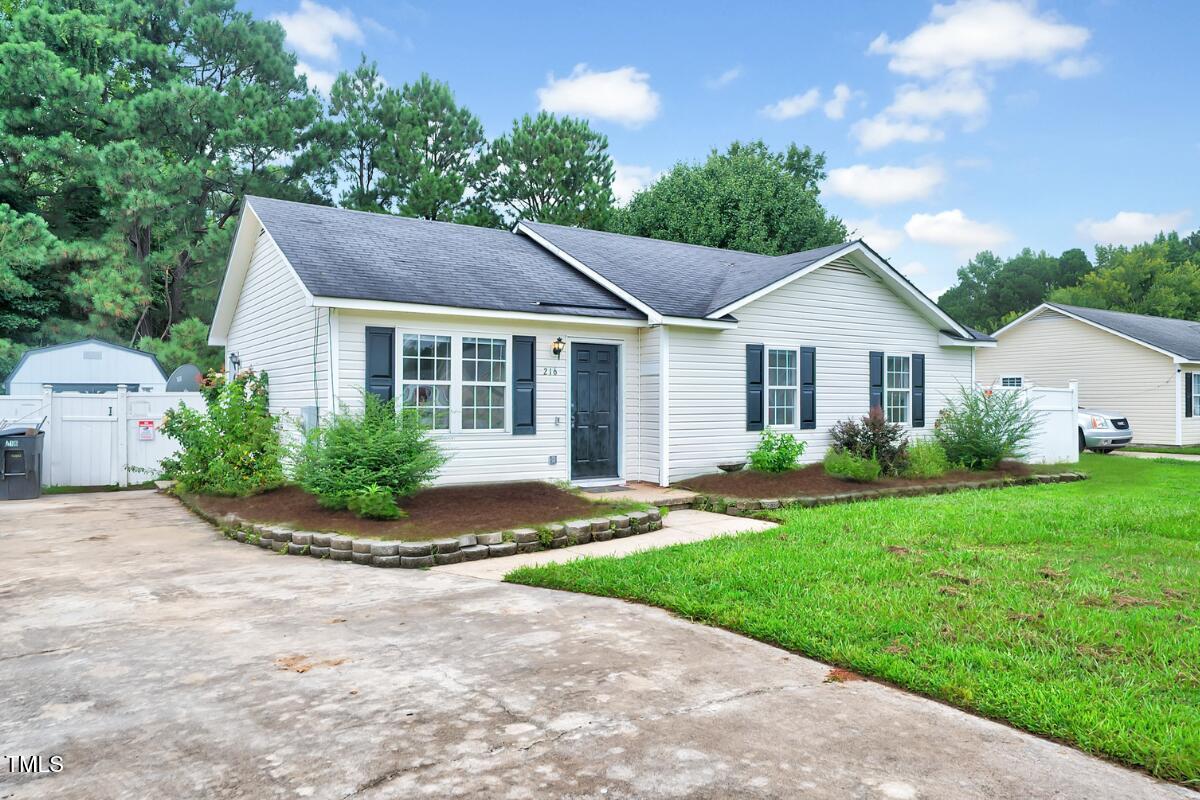 216 Katie Drive Rocky Mount, NC 27803 - Photo 2 of 27 a front view of a house with a yard and garage
