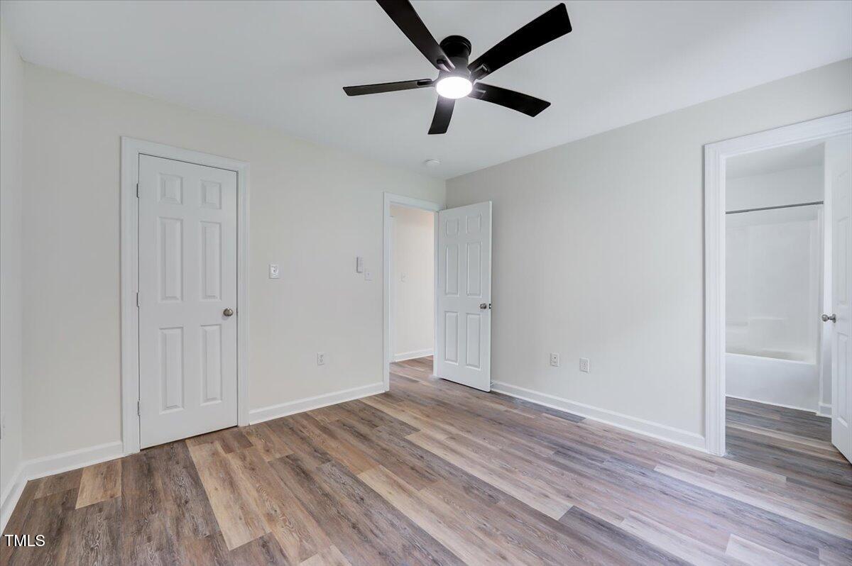 216 Katie Drive Rocky Mount, NC 27803 - Photo 26 of 27 an empty room with wooden floor and ceiling fan
