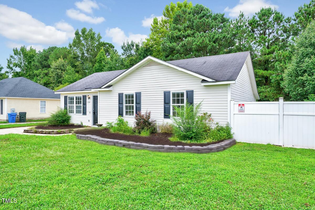 216 Katie Drive Rocky Mount, NC 27803 - Photo 3 of 27 a house that is sitting in middle of the grass