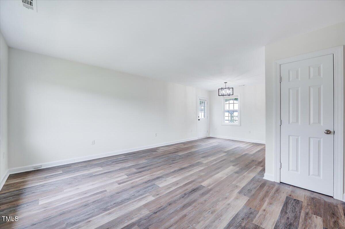 216 Katie Drive Rocky Mount, NC 27803 - Photo 5 of 27 an empty room with wooden floor and windows