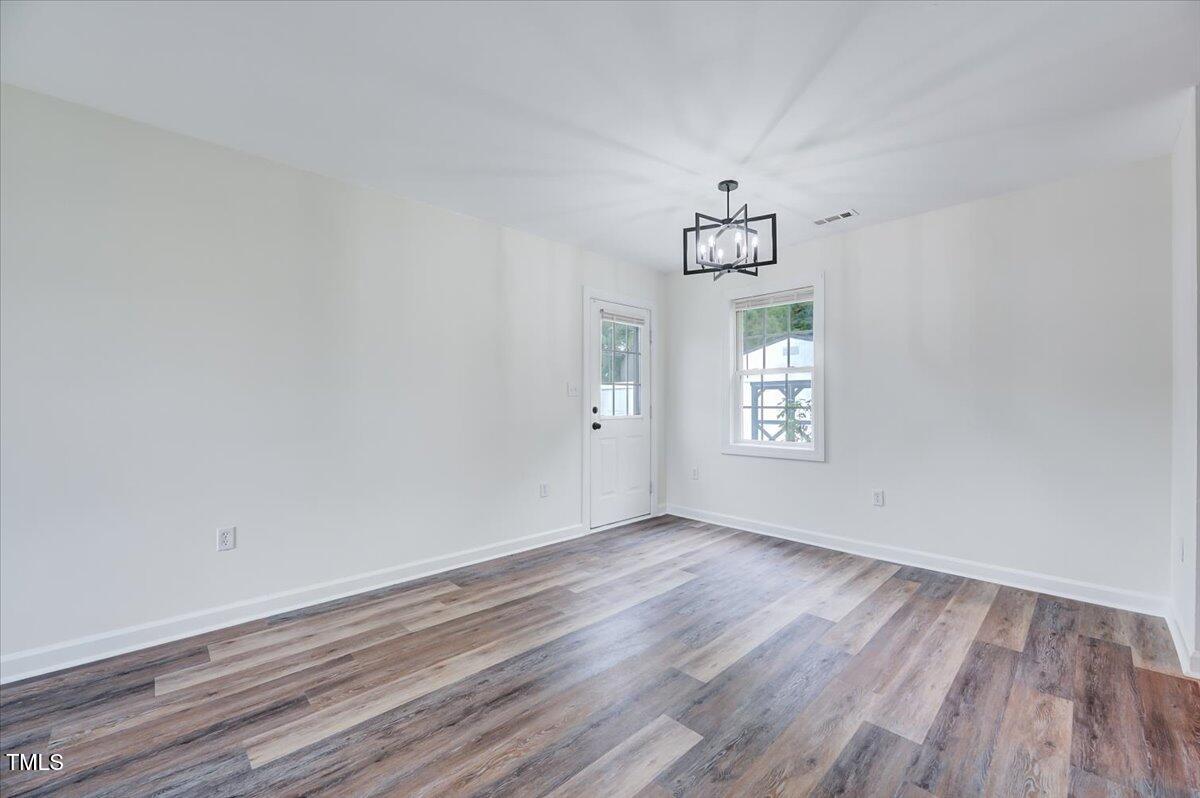 216 Katie Drive Rocky Mount, NC 27803 - Photo 9 of 27 wooden floor in an empty room with a window